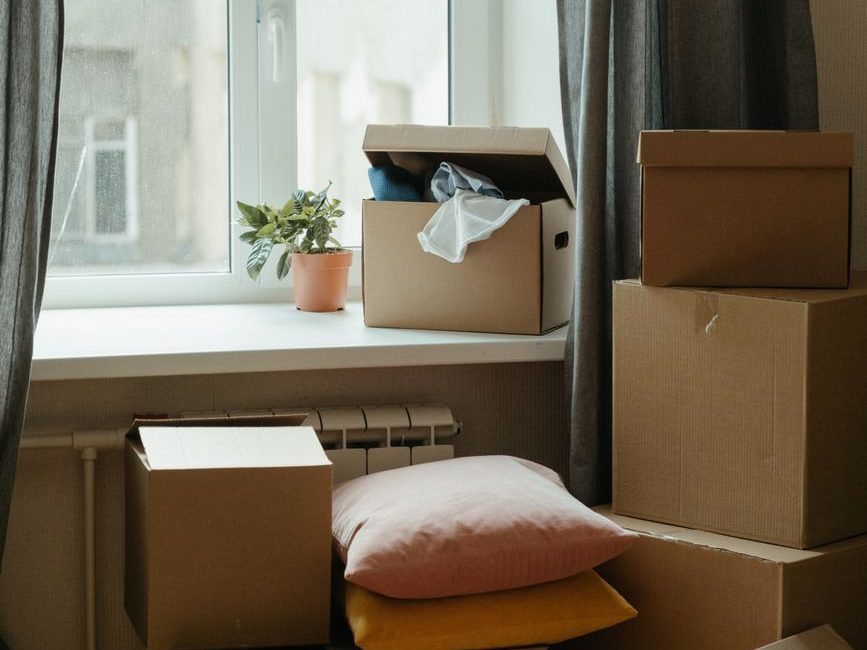 Basic household items and moving boxes in a new apartment