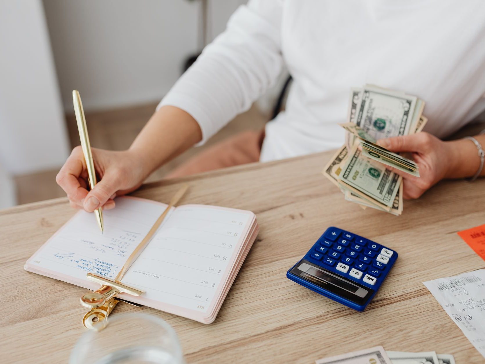 Simple budgeting workspace with notebook, calculator, and money